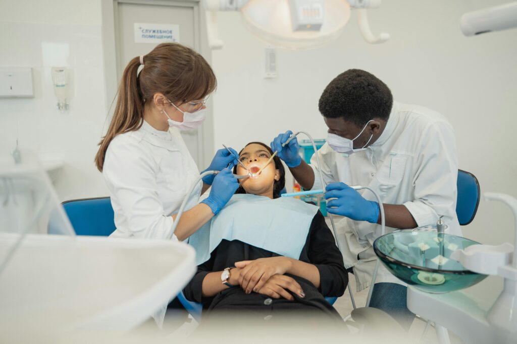 "how to choose the best dentist in varanasi for your smile"in 2025. best dental professionals treat a patient in a modern clinic setting.