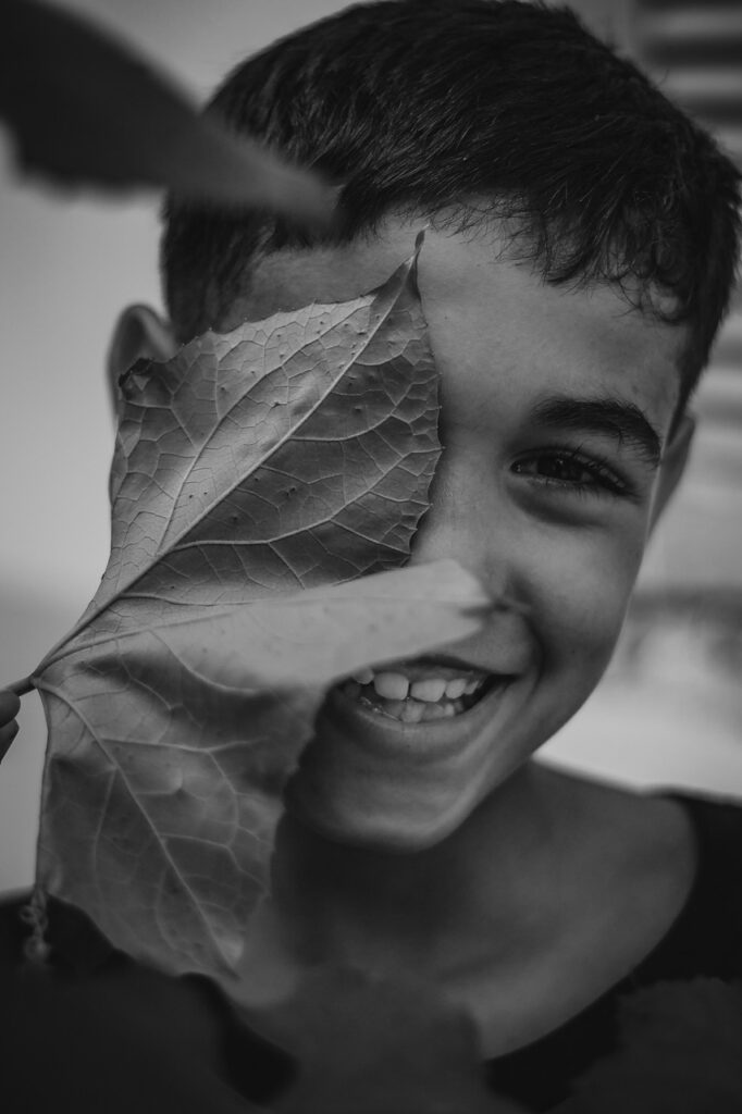 smile, boy, kid, leaf, happy, child, portrait, smiling, laughing, cute, young, face, creative, black and white, nature, emotion, outdoor, leaves, one eye, inspiration, photo, photos, great smile, love, valentines, happy valentines